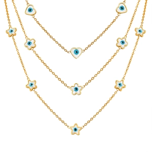 Three-layer gold evil eye necklace with heart and star charms on white background