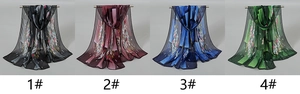 Detail view of four lightweight chiffon scarves with elegant floral patterns in various colors