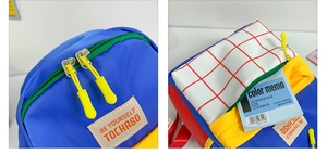 Close-up of color-block canvas kids backpack with smooth zippers and durable stitching