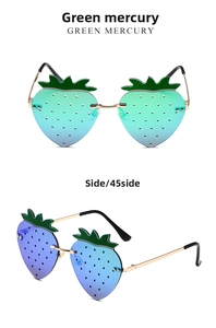 Close-up of strawberry-shaped sunglasses with green mercury gradient lenses and gold frame