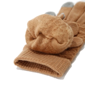 Detail of warm brown knit gloves with thick fleece lining and gray touchscreen fingertips
