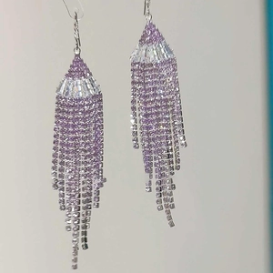 Close-up of purple and silver tassel earrings featuring sparkling cubic zirconia stones