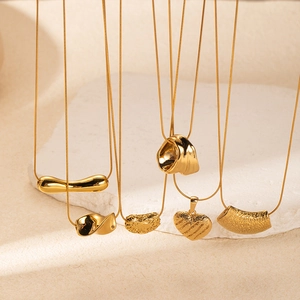 Golden titanium steel necklaces with heart and geometric bar pendants on stone base
