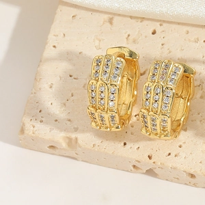 Macro view of French vintage hollow gold hoop earrings with multi-row zircon inlay