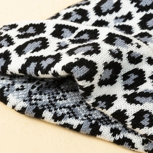 Close-up of leopard print knit fabric showing soft texture and thick winter material