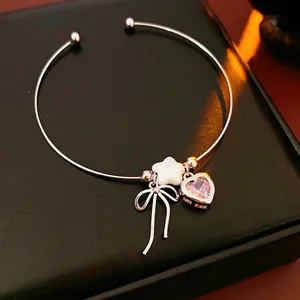 Silver open bangle with pink heart crystal, white star charm and bow pendant decoration