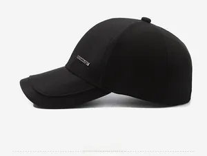 Detail shot of black baseball cap featuring a premium silver metal logo plaque on the side