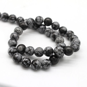 Natural snowflake stone round loose beads for DIY jewelry making on white background