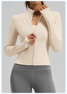 Close-up of slim-fit athletic zip-up jacket featuring thumb holes and high collar detail
