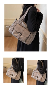 Detail of grey vintage leather tote bag with lychee texture and multi-pocket design