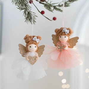 Detail of angel dolls with lace bows and glitter wings hanging on green pine branches