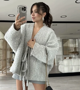 Detailed texture of fluffy light gray faux mink mohair cardigan with belted waist design