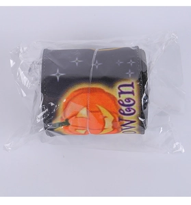 Detail view of Halloween pumpkin print ribbon roll packaged in clear plastic wrap