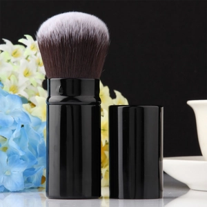 Portable retractable makeup brush with black finish and soft gradient synthetic fibers