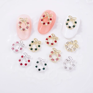 Christmas wreath and bow nail charms with colorful rhinestones and pearls on nails