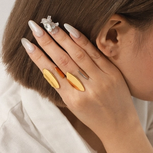 Minimalist geometric stainless steel rings in gold and silver finish on a female model