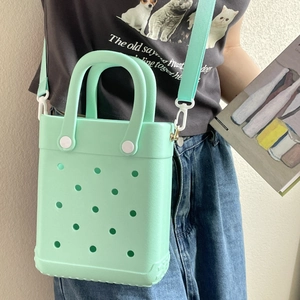 Mint green EVA hole tote bag featuring detachable shoulder strap and matte finish