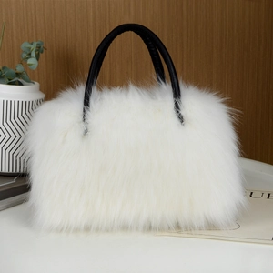 Detail shot of the white faux fur texture and black leather handles of this luxury tote bag