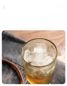 Close-up of vintage embossed glass rim showing smooth finish and palm leaf patterns