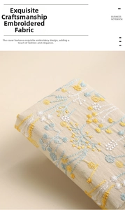 Detailed close-up of floral embroidery on linen A6 business notebook cover