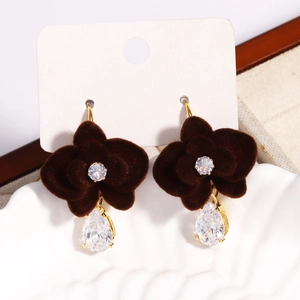 Close-up of geometric velvet flower tassel earrings with zircons on display tray