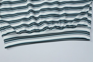 Close-up of the striped knit hem with refined ribbed cuffs and high-quality fabric texture