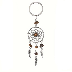 Detail view of silver dreamcatcher keychain with brown crystal stones and metal feathers