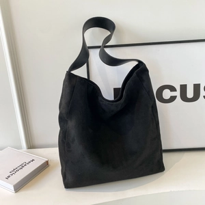 Minimalist black matte suede tote bag with spacious interior and wide shoulder straps