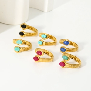 Macro detail of 18k gold plated stainless steel rings with colorful natural stones