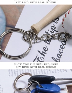 Detail of wooden baseball bat and mini softball keychain with silver metal ring