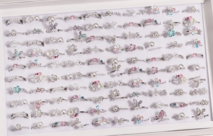 Detail of silver rings collection featuring zircon butterfly and floral designs