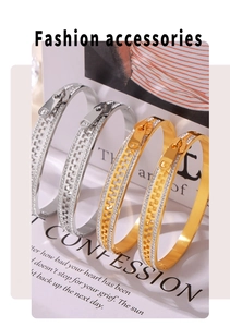 Close-up of gold and silver zipper-shaped bangles with cubic zirconia inlay details