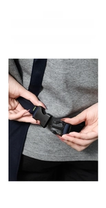 Close-up of the adjustable plastic buckle and nylon strap on a canvas apron waist