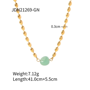 Gold bead chain necklace with natural light green stone pendant on white background