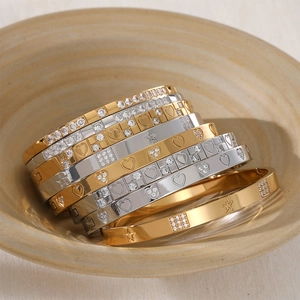 Luxury stainless steel rhinestone bangles featuring heart and star engravings in gold and silver