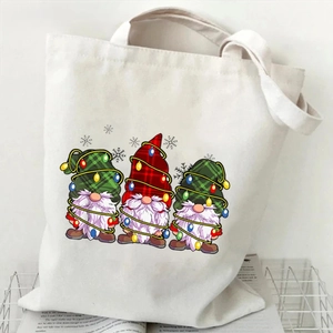 Detail of Christmas gnomes print on a cream canvas tote bag with festive holiday patterns