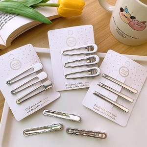Set of silver Y2K metallic hair clips in various hollow designs on a white tray