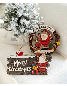 Close-up of Santa and Reindeer rattan Welcome sign and Merry Christmas wooden plaque