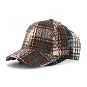 Detailed view of layered plaid baseball caps in wool blend fabric with curved brims