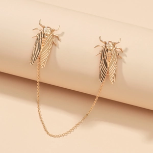Detailed close-up of golden cicada brooch pins with elegant connecting metal chain