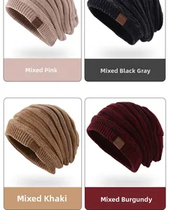 Close-up of knit beanies in mixed pink, grey, khaki and burgundy with leather patches