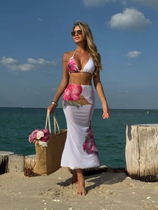 Detail of floral mesh maxi skirt and bikini set showing fabric texture and vibrant print