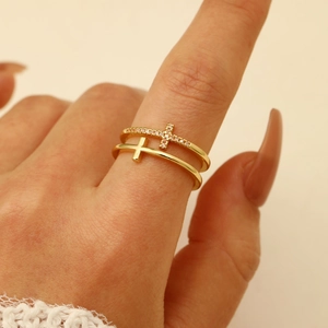 Detailed close-up of double-layer gold cross ring with micro-set white zircon stones