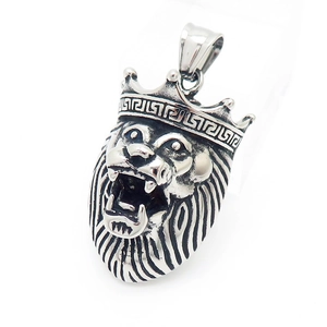Detailed close-up of a silver lion head pendant with crown and vintage texture