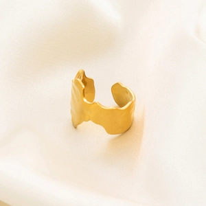 Close-up of gold 18K plated stainless steel ring with irregular hammered texture detail