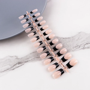 Detailed set of 24 pieces of black french tip almond shaped press-on nails on a clear stand