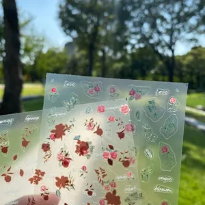 Japanese style golden floral nail stickers with rose patterns on transparent PET backing