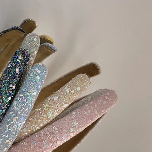 Detail of colorful sequined headbands in black, blue, gold, and pink with fabric lining