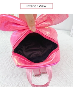 Detail view of pink glitter backpack interior with zipper closure and black lining