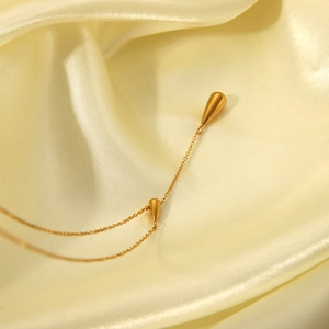 Minimalist 18K gold plated stainless steel necklace with double teardrop pendants on silk